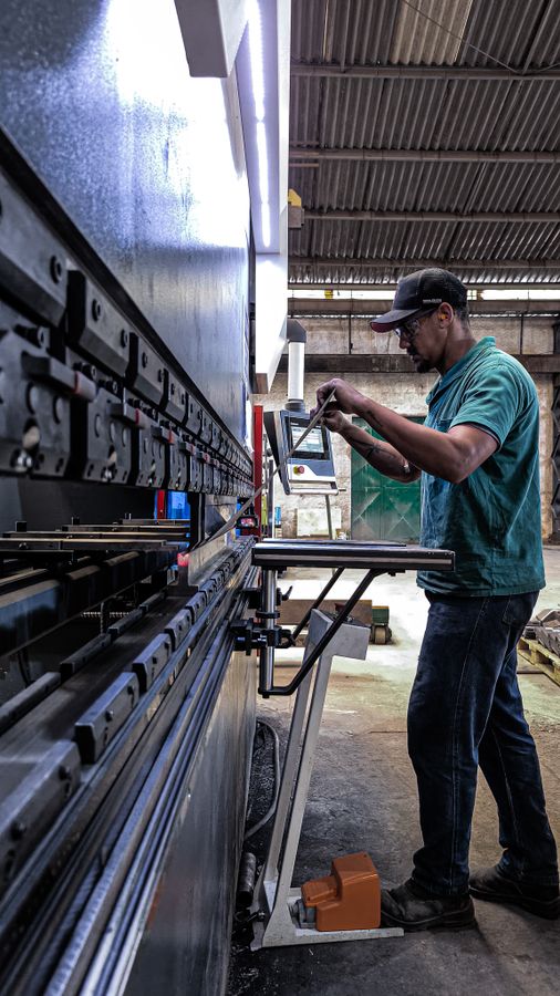 Engineer operating machinery in an industrial workshop
